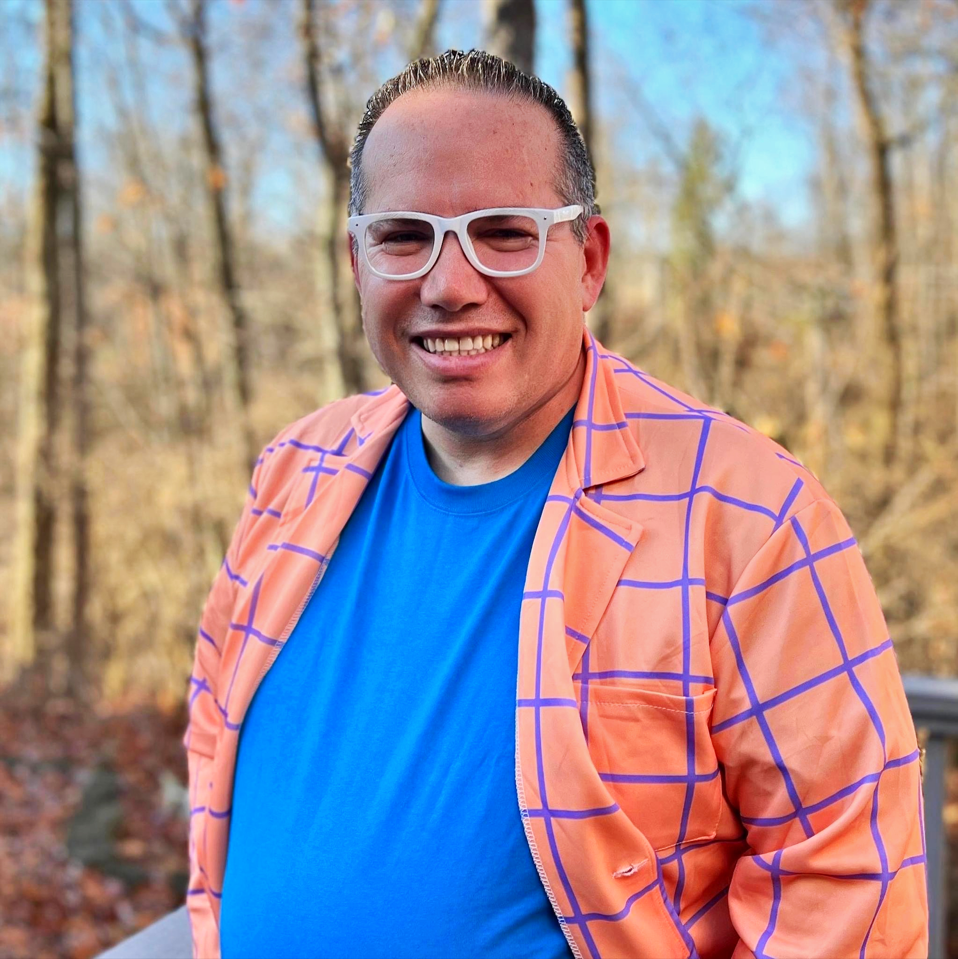 Phil Gerbyshak is a white man with short hair white framed glasses and a big smile