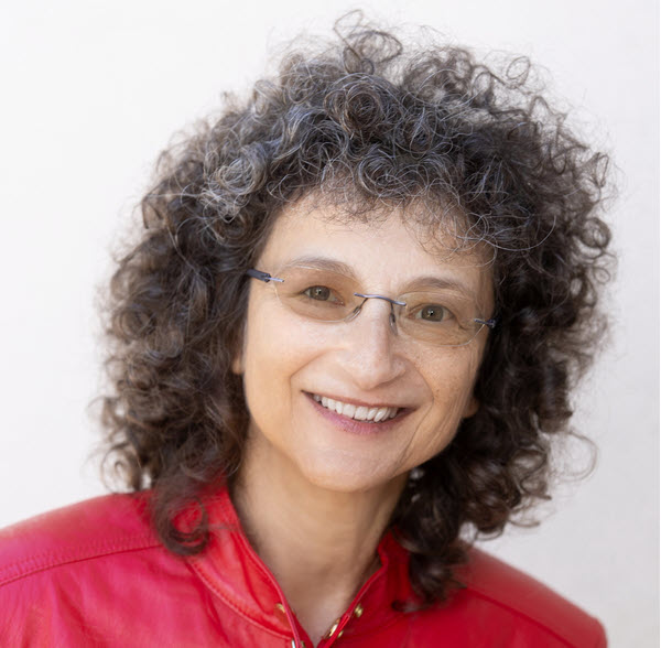 white woman with glasses, brown hair, and a red shirt smiling at the camera