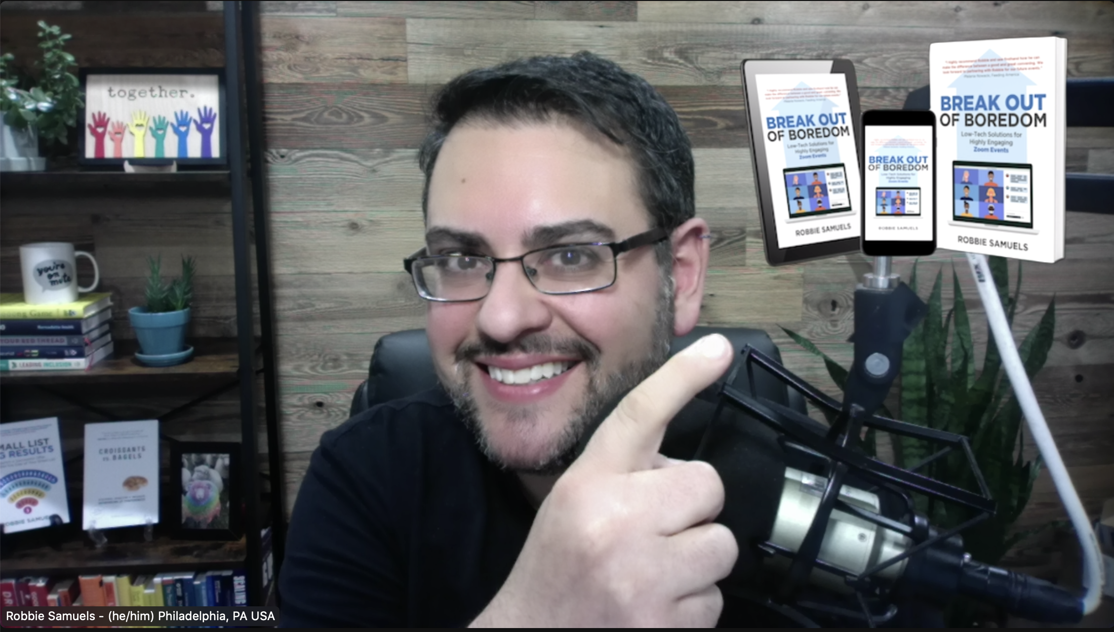 Robbie pointing to a custom video filter showing his book cover