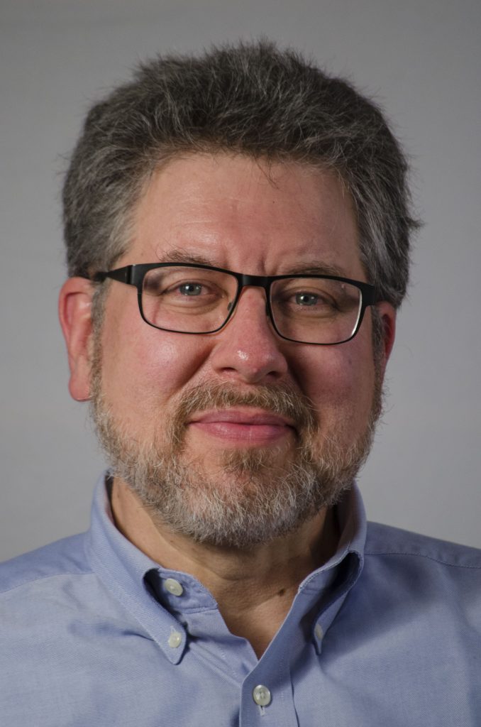 Josh Bernoff is a white man with short salt and pepper hair and a beard